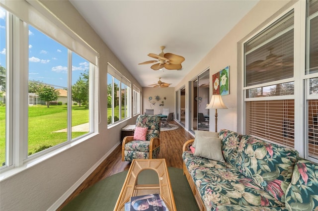 sunroom / solarium featuring vaulted ceiling, a wealth of natural light, and ceiling fan