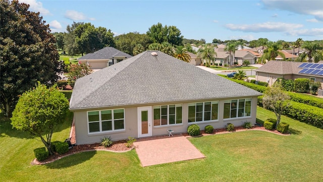 rear view of property featuring a patio area and a yard