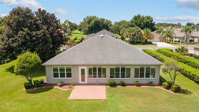 rear view of property with a yard