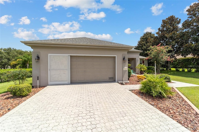 view of front of home featuring a garage and a front lawn