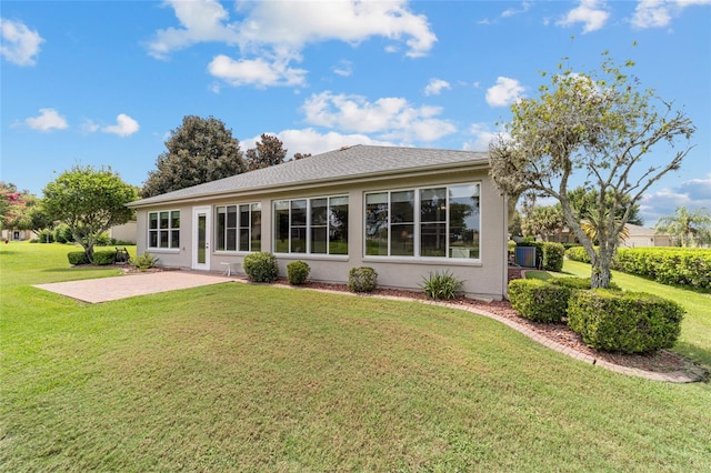 rear view of property featuring a yard