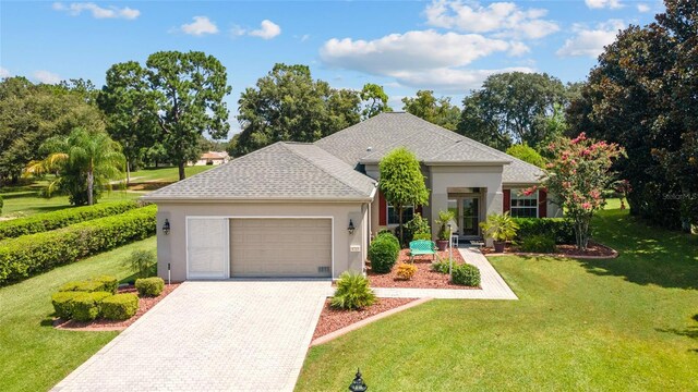 view of front of home with a front yard and a garage