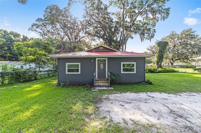 bungalow-style house featuring a front yard