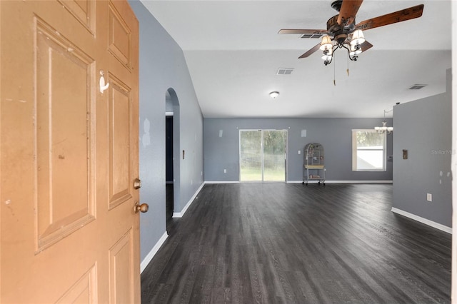 unfurnished living room with dark hardwood / wood-style floors, ceiling fan with notable chandelier, and lofted ceiling