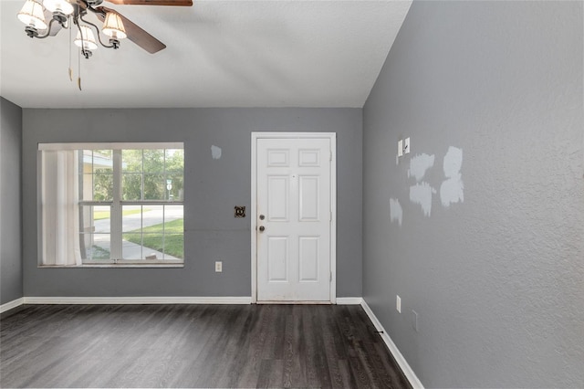 entryway featuring ceiling fan with notable chandelier and hardwood / wood-style floors