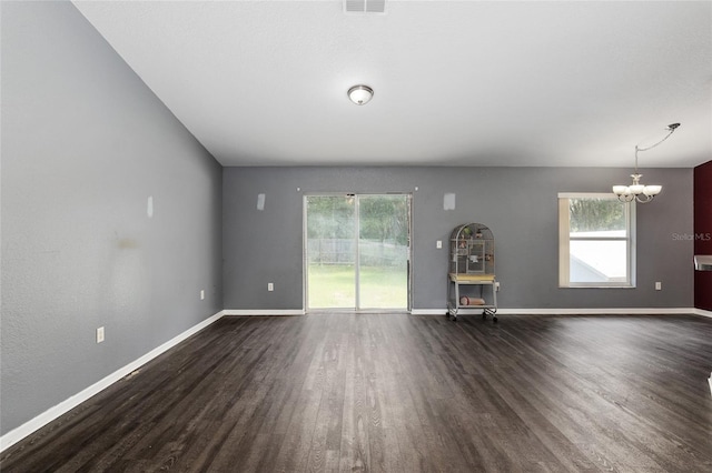 interior space featuring dark wood-type flooring and a chandelier