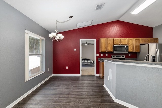 kitchen with pendant lighting, stainless steel appliances, dark hardwood / wood-style flooring, ceiling fan with notable chandelier, and vaulted ceiling