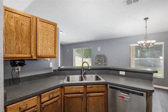 kitchen with decorative light fixtures, dishwasher, sink, and kitchen peninsula