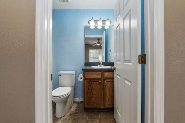 bathroom with vanity, tile patterned flooring, ceiling fan, and toilet