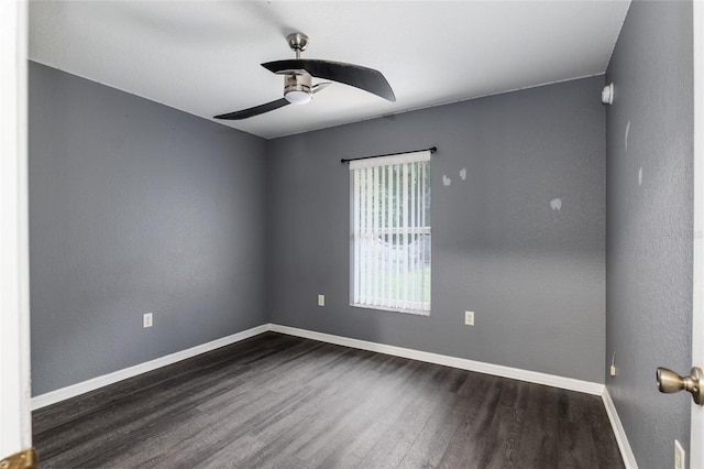 empty room featuring ceiling fan and dark hardwood / wood-style flooring