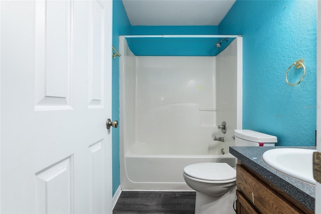 full bathroom featuring wood-type flooring, shower / bathing tub combination, toilet, and vanity