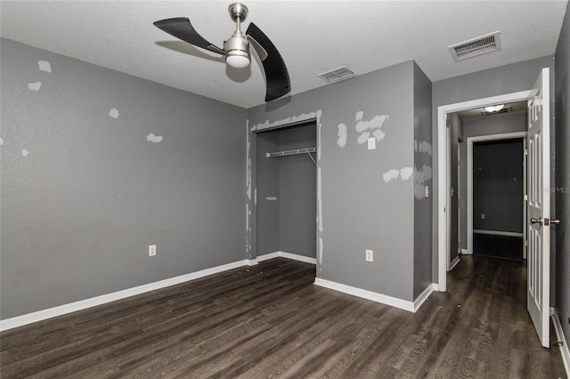 unfurnished bedroom featuring a textured ceiling, a closet, wood-type flooring, and ceiling fan