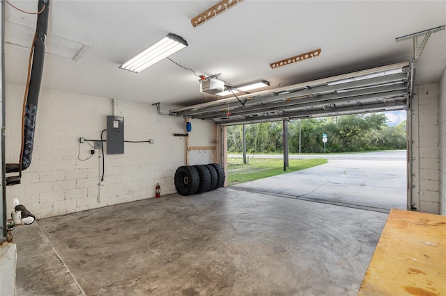 garage with a garage door opener and electric panel