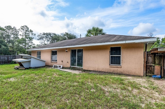 back of property featuring a yard