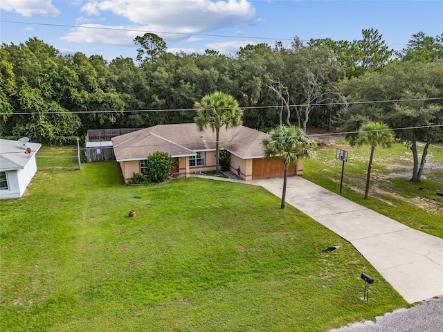 view of front of property featuring a garage and a front lawn