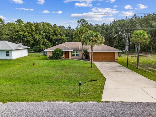 single story home featuring a garage and a front lawn