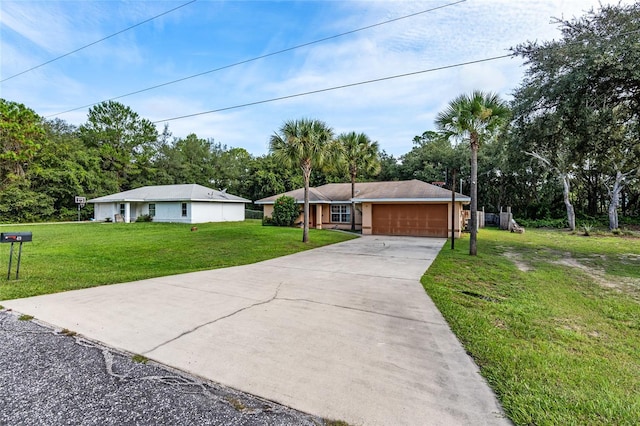 single story home with concrete driveway, a garage, and a front lawn