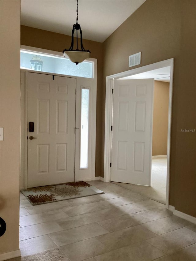 foyer featuring lofted ceiling