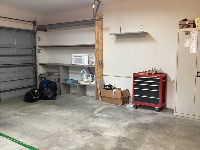 garage featuring a wall mounted air conditioner