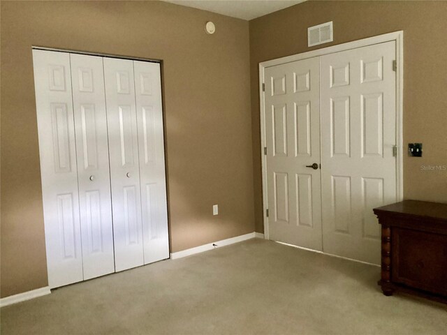 unfurnished bedroom featuring light carpet