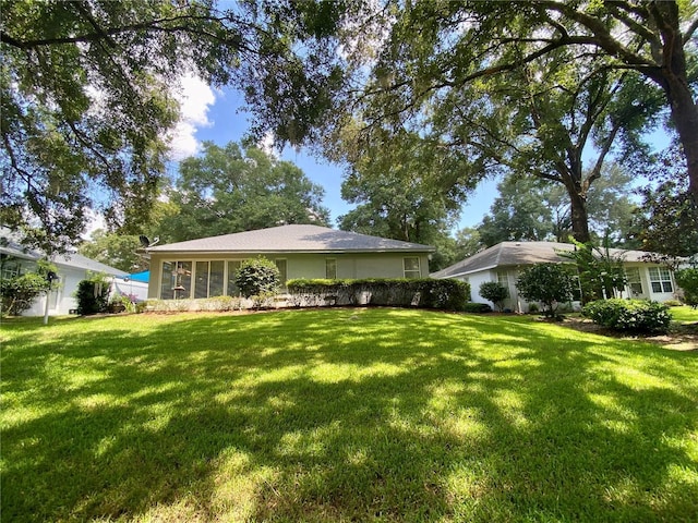 9288 SW 192nd Court Rd, Dunnellon, FL 34432 - back of property featuring a yard and a sunroom
