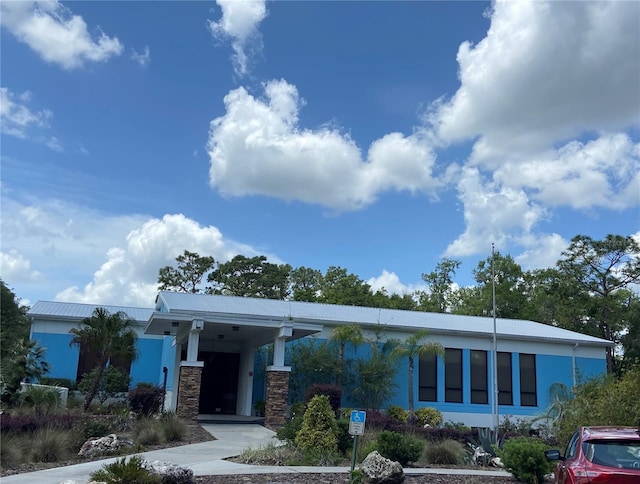 9288 SW 192nd Court Rd, Dunnellon, FL 34432 - view of front of home with stone siding, metal roof, an attached carport, and stucco siding