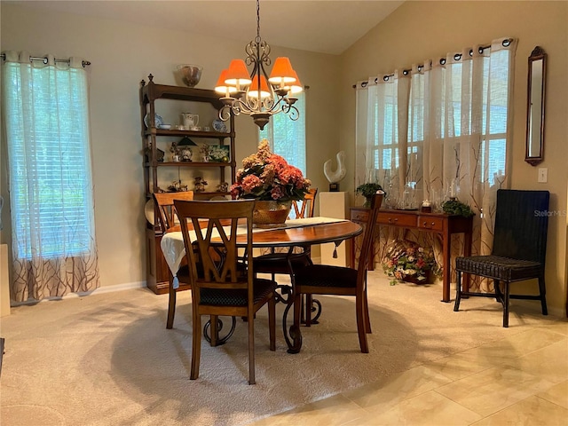 carpeted dining room with a chandelier and vaulted ceiling