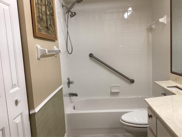 full bathroom featuring toilet, tiled shower / bath combo, and vanity