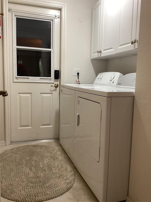 9288 SW 192nd Court Rd, Dunnellon, FL 34432 - washroom with light tile patterned floors, cabinet space, and separate washer and dryer