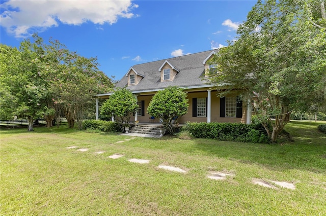 cape cod home with a porch and a front lawn