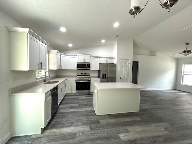 kitchen featuring white cabinetry, sink, stainless steel appliances, and a kitchen island