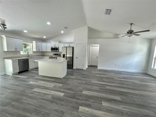 kitchen featuring ceiling fan, a center island, sink, appliances with stainless steel finishes, and white cabinets