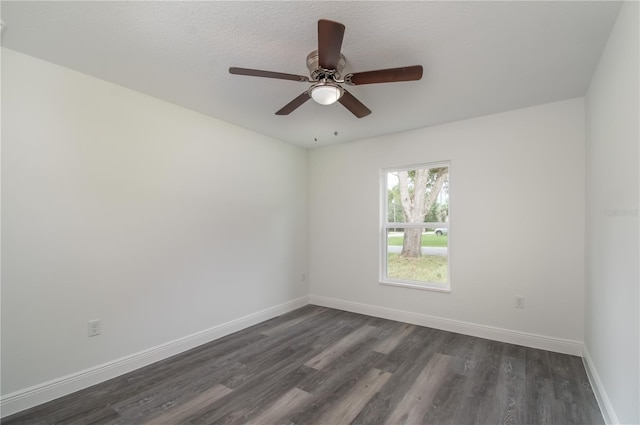 empty room featuring ceiling fan, dark hardwood / wood-style floors, and a textured ceiling