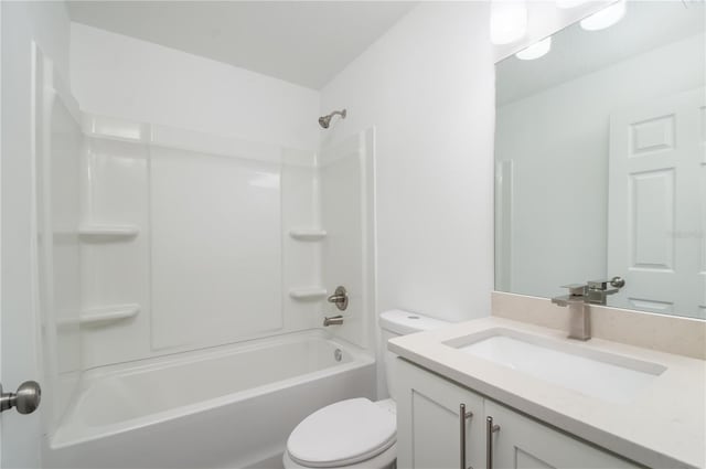 full bathroom featuring toilet, vanity, and tub / shower combination