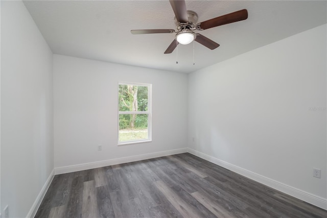 empty room with ceiling fan and dark hardwood / wood-style flooring