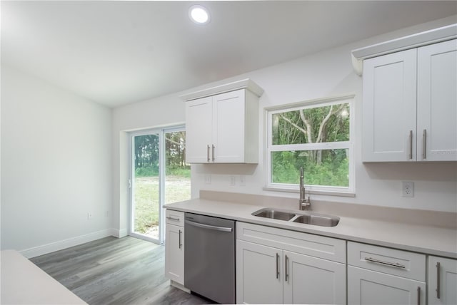 kitchen with sink, white cabinets, stainless steel dishwasher, and light wood-type flooring