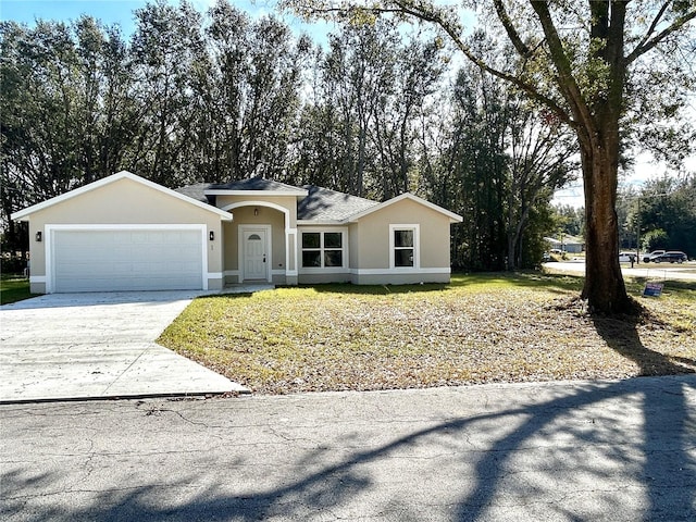 ranch-style house featuring a garage, driveway, and stucco siding