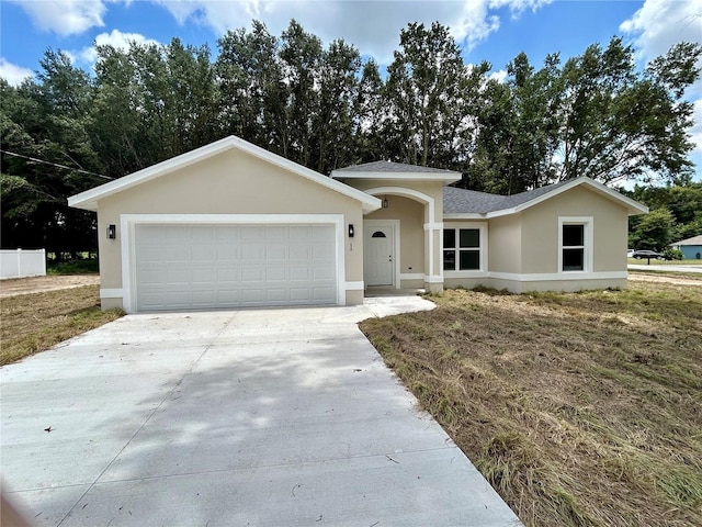 single story home featuring driveway, an attached garage, roof with shingles, and stucco siding