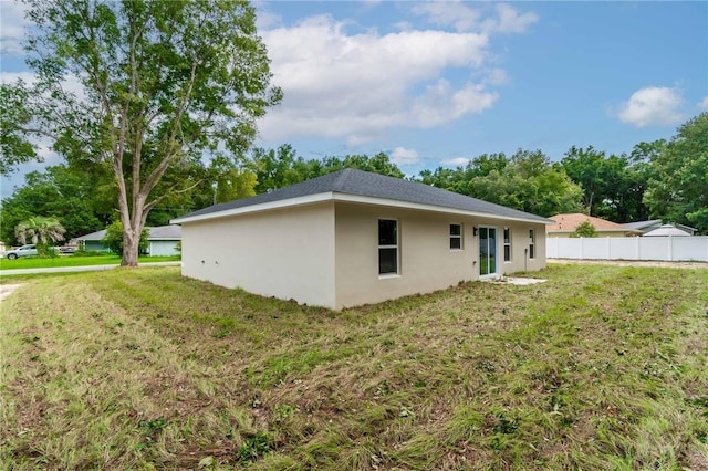 rear view of property featuring a yard