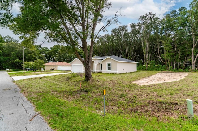 single story home with a front lawn and a garage