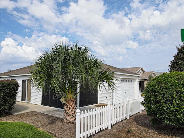 view of side of property with a garage