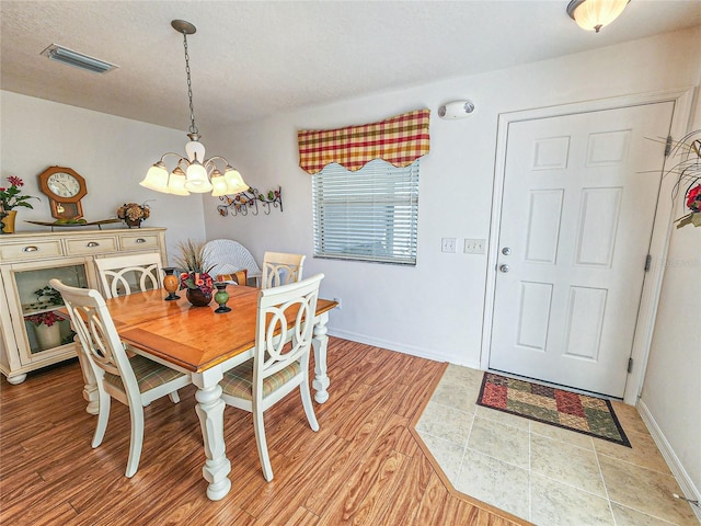 dining area featuring a chandelier and light hardwood / wood-style flooring