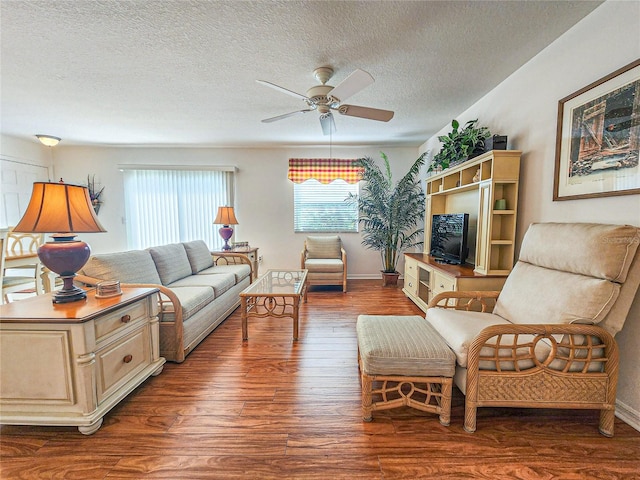 living room with a textured ceiling, ceiling fan, and hardwood / wood-style floors