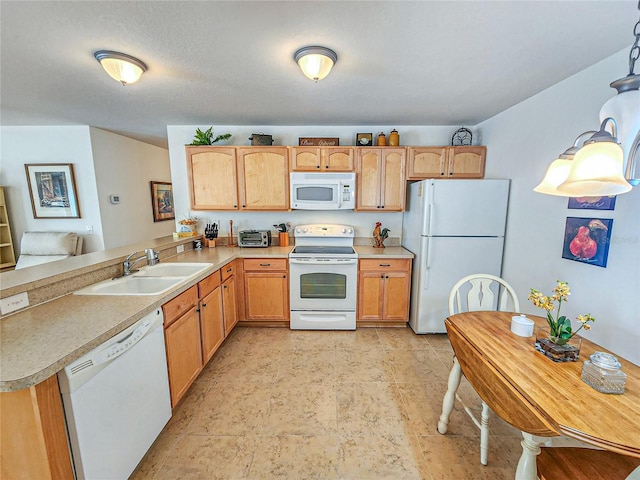 kitchen with light tile patterned flooring, hanging light fixtures, light brown cabinets, white appliances, and sink