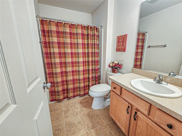 bathroom with vanity, tile patterned flooring, and toilet