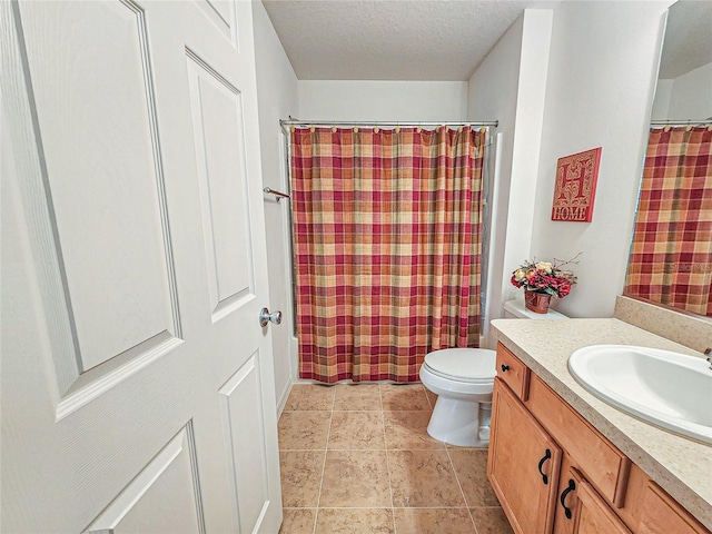 bathroom with vanity, tile patterned floors, a textured ceiling, and toilet