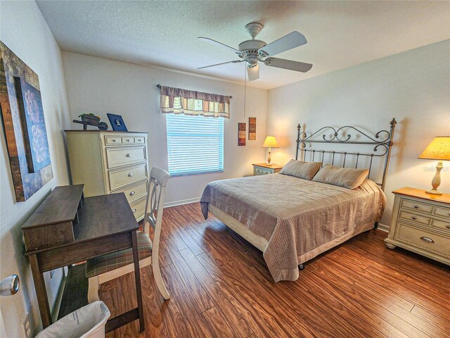 bedroom featuring hardwood / wood-style flooring, a textured ceiling, and ceiling fan