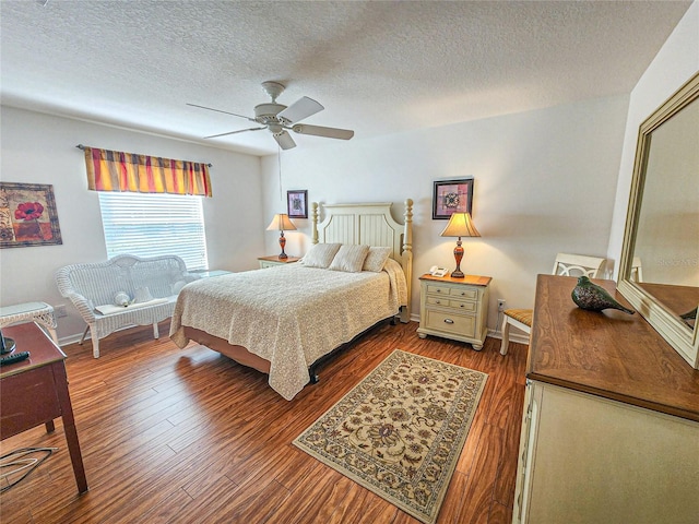 bedroom featuring ceiling fan, wood-type flooring, and a textured ceiling