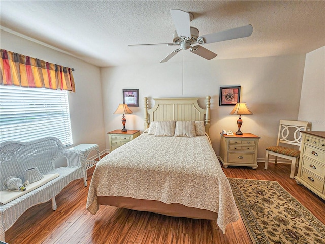 bedroom featuring a textured ceiling, hardwood / wood-style floors, and ceiling fan