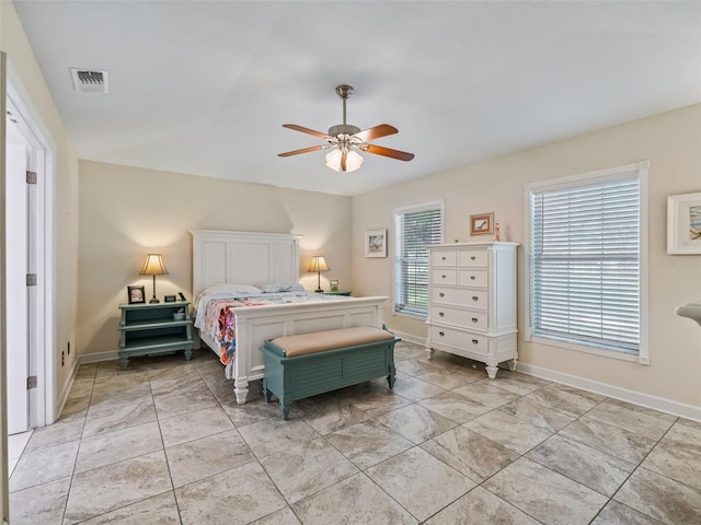 bedroom featuring ceiling fan and multiple windows